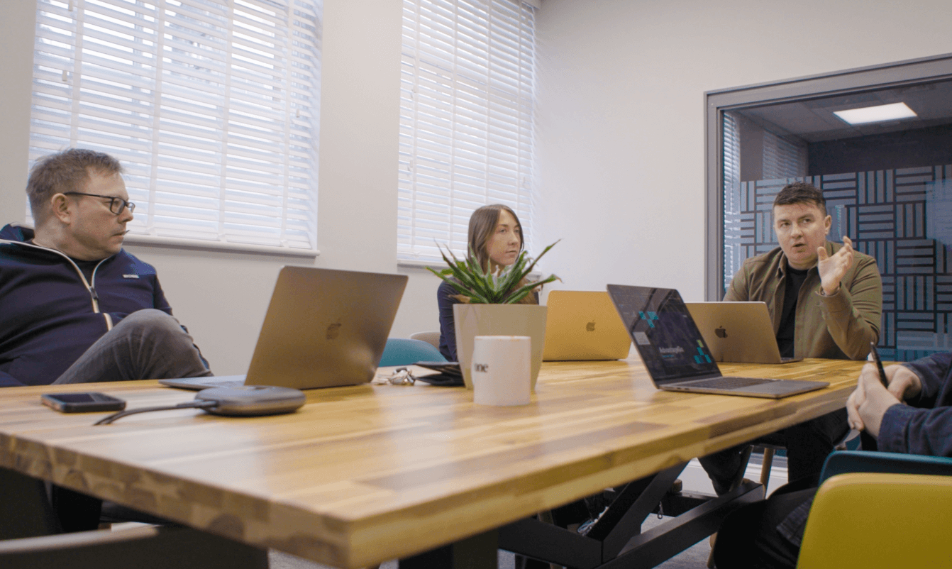 team members sitting at table talking